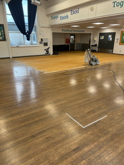 Restaurant Floor Sanding in Honoroak at the Rashford Restaurant dining hall, showing a half-sanded solid hardwood strip floor with a clear before-and-after contrast.