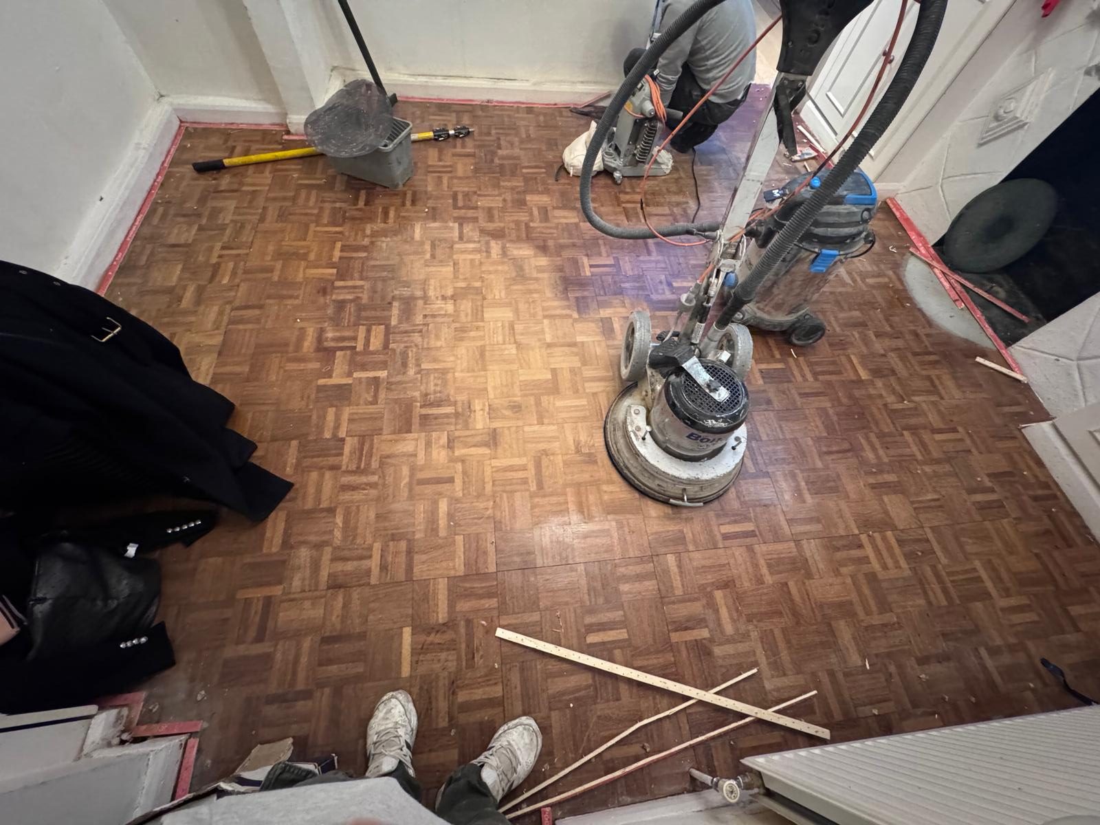 Wood Floor Sanding in Honor Oak on an oak mosaic parquet floor, showing a professional sanding machine in use during restoration.